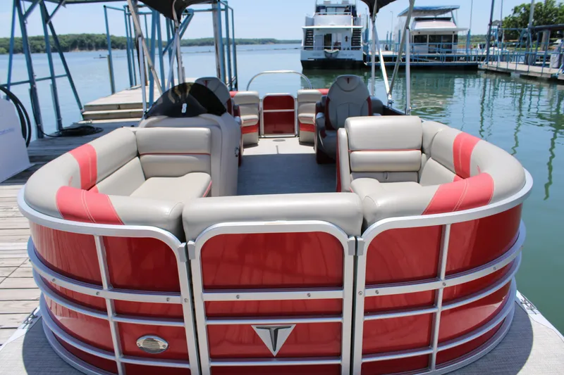 Slide: The Image of 2022 Trifecta 24RF LE pontoon boat with red and beige seating at a dock. - 4