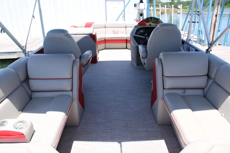 Slide: The Image of 2022 Trifecta 24RF LE pontoon boat interior with gray and red seating. - 5