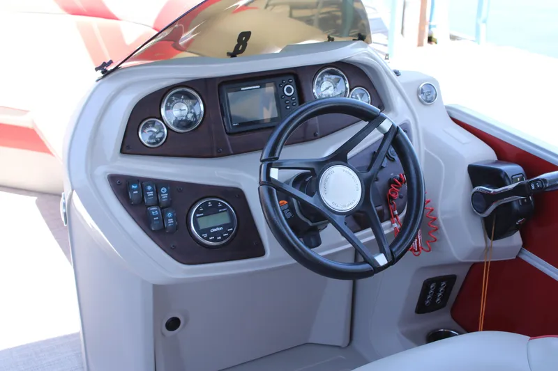 Slide: The Image of 2022 Trifecta 24RF LE boat dashboard with steering wheel and control panel. - 6