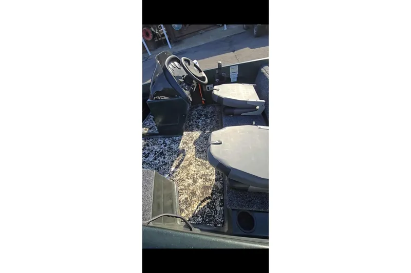 Slide: The Image of Interior of a 1995 Nitro 170 TF boat with steering wheel and seating. - 3