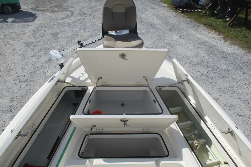 Slide: The Image of 2014 Skeeter SX240 boat with open storage compartments and seating. - 10