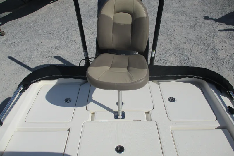 Slide: The Image of 2014 Skeeter SX240 boat seat and deck, featuring beige upholstery and storage compartments. - 12
