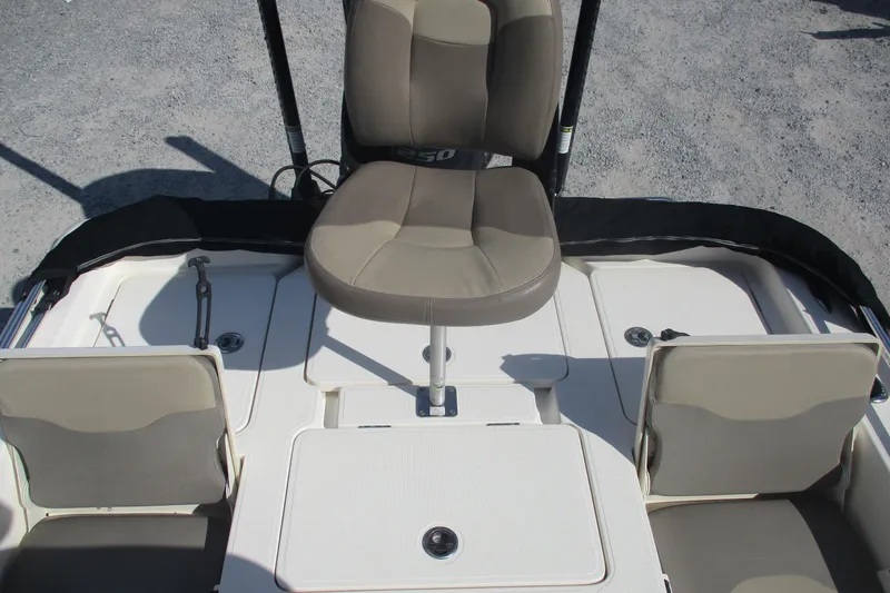 Slide: The Image of 2014 Skeeter SX240 boat interior with seating and storage compartments. - 13