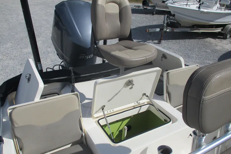 Slide: The Image of 2014 Skeeter SX240 boat interior with open storage compartments and seating. - 14
