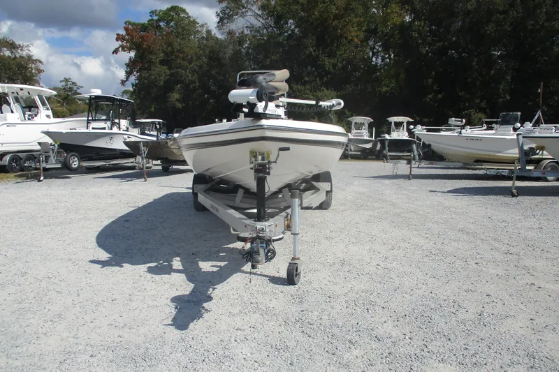 Slide: The Image of 2014 Skeeter SX240 boat on trailer in outdoor lot with other boats. - 2