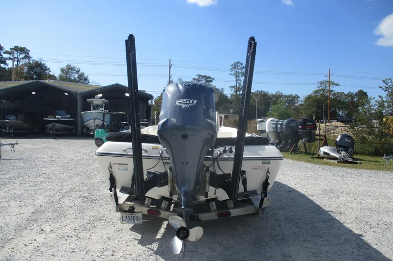 Slide: The Image of 2014 Skeeter SX240 boat with Yamaha 250 V6 engine, parked outdoors. - 5