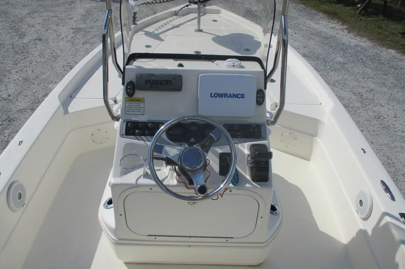 Slide: The Image of 2014 Skeeter SX240 boat console with steering wheel and navigation equipment. - 6