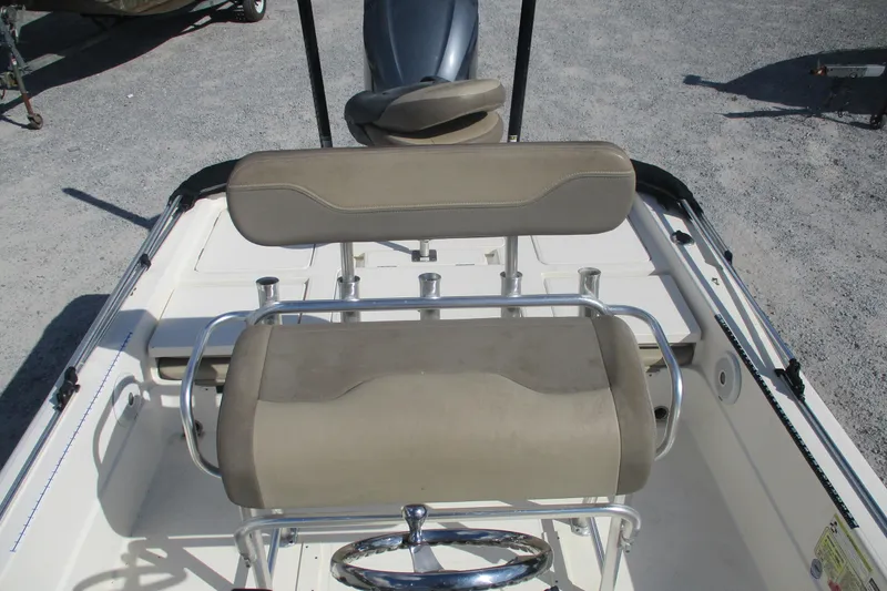 Slide: The Image of 2014 Skeeter SX240 boat interior with beige seating and steering wheel. - 8