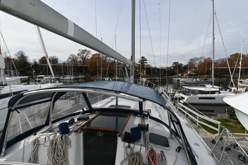 Slide: The Image of 2001 Beneteau 361 sailboat with blue canopy docked at marina. - 15