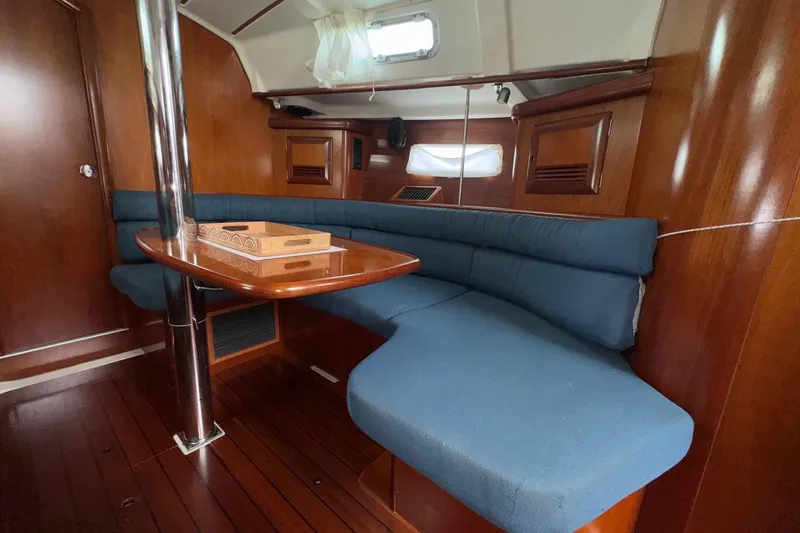 Slide: The Image of 2001 Beneteau Oceanis Clipper 361 yacht kitchen with stove, microwave, and wooden cabinetry. - 27