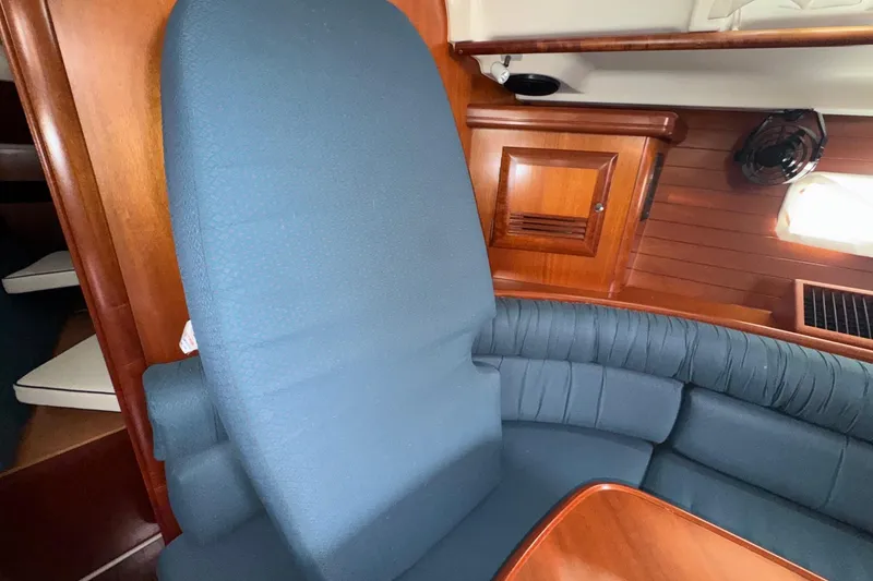 Slide: The Image of Interior of 2001 Beneteau Oceanis Clipper 361 with blue seating and wooden cabinetry. - 37