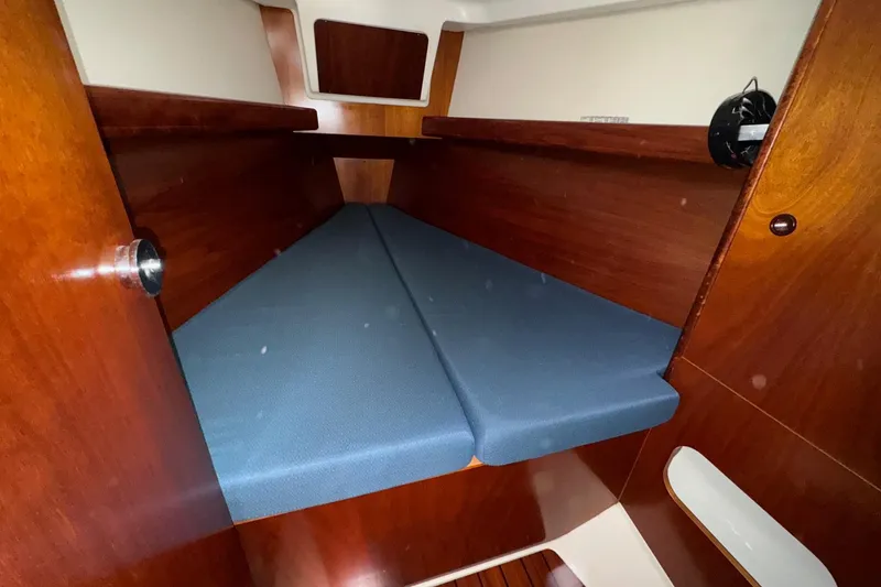 Slide: The Image of Interior cabin of 2001 Beneteau Oceanis Clipper 361 with blue cushions and wooden finish. - 38