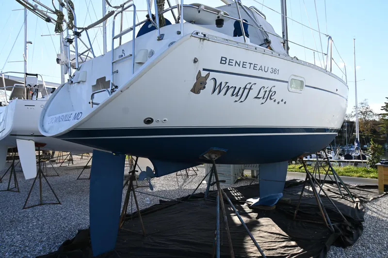 Slide: The Image of 2001 Beneteau Oceanis Clipper 361 sailboat on stands, named "Wruff Life," in a boatyard. - 4