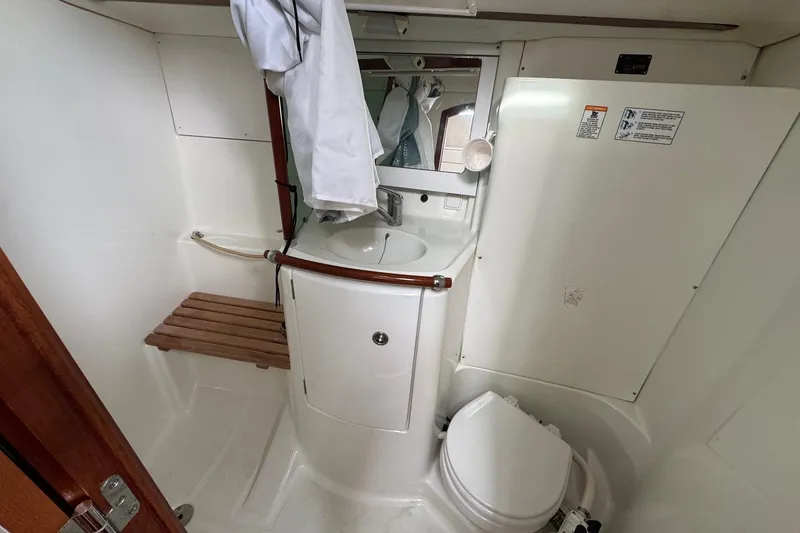 Slide: The Image of Bathroom of 2001 Beneteau Oceanis Clipper 361 yacht with sink, toilet, and mirror. - 41