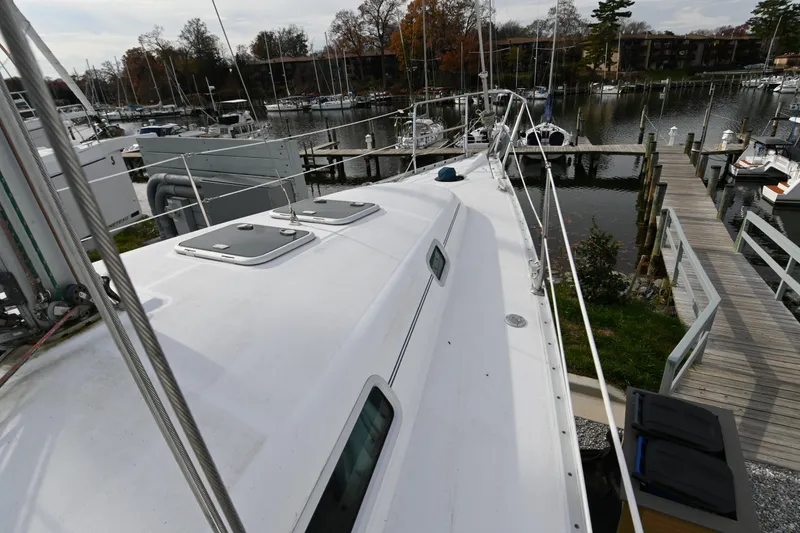 Slide: The Image of 2001 Beneteau Oceanis Clipper 361 sailboat docked at a marina, view of deck and surroundings. - 11