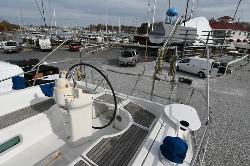 Slide: The Image of 2001 Beneteau Oceanis Clipper 361 sailboat in marina, showcasing deck and steering wheel. - 14