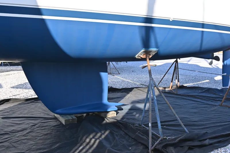 Slide: The Image of 2001 Beneteau Oceanis Clipper 361 sailboat hull on stands, blue and white design. - 16