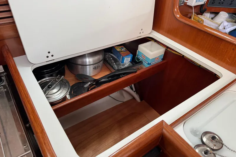 Slide: The Image of Storage compartment in a 2001 Beneteau Oceanis Clipper 361 yacht galley with kitchenware. - 17