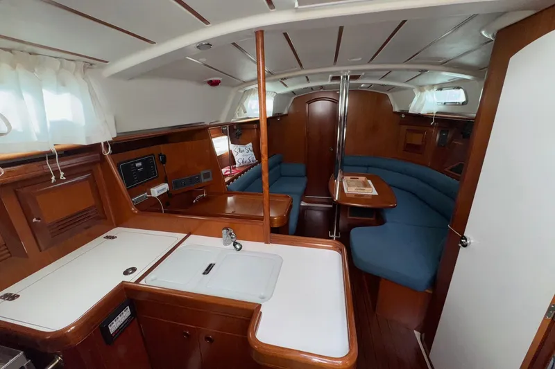 Slide: The Image of Interior of 2001 Beneteau Oceanis Clipper 361 yacht with wood finish and blue seating. - 22