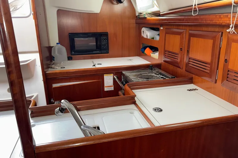 Slide: The Image of Interior of 2001 Beneteau Oceanis Clipper 361 yacht kitchen with wood cabinetry and appliances. - 24