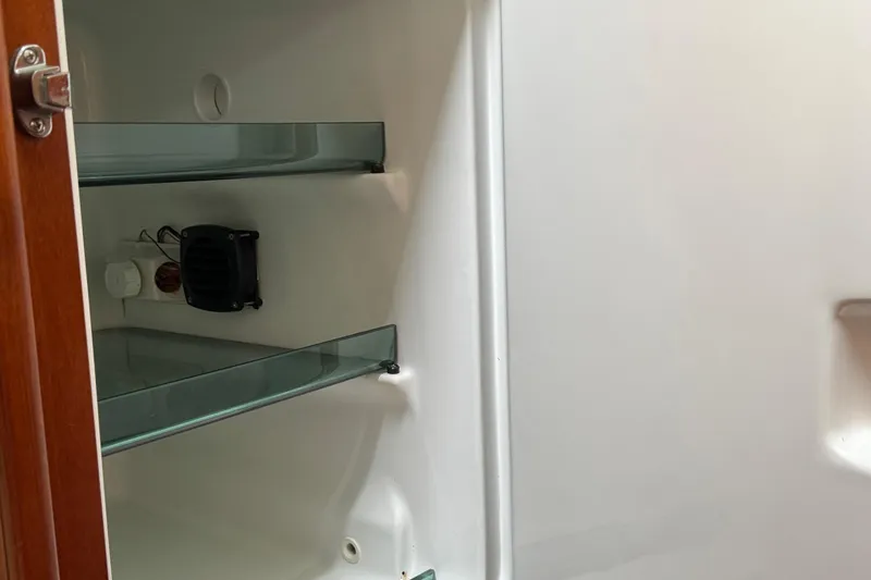 Slide: The Image of Interior of Beneteau Oceanis Clipper 361 refrigerator, 2001 model, with glass shelves. - 36