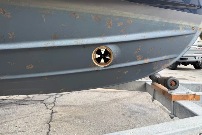 Slide: The Image of 2008 Ranger Tugs R-25 boat hull with visible rust spots on a trailer. - 13
