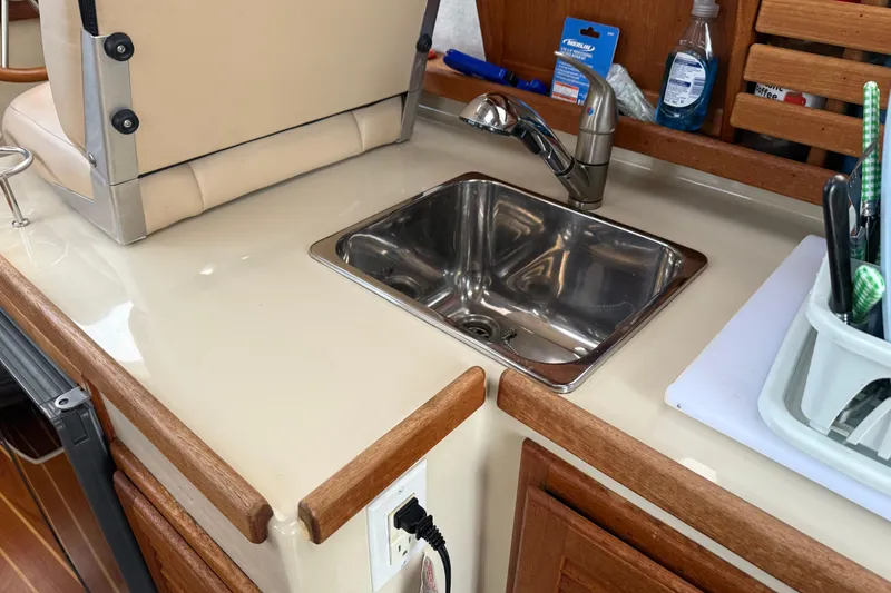 Slide: The Image of 2008 Ranger Tugs R-25 boat interior with compact kitchen sink and faucet. - 26