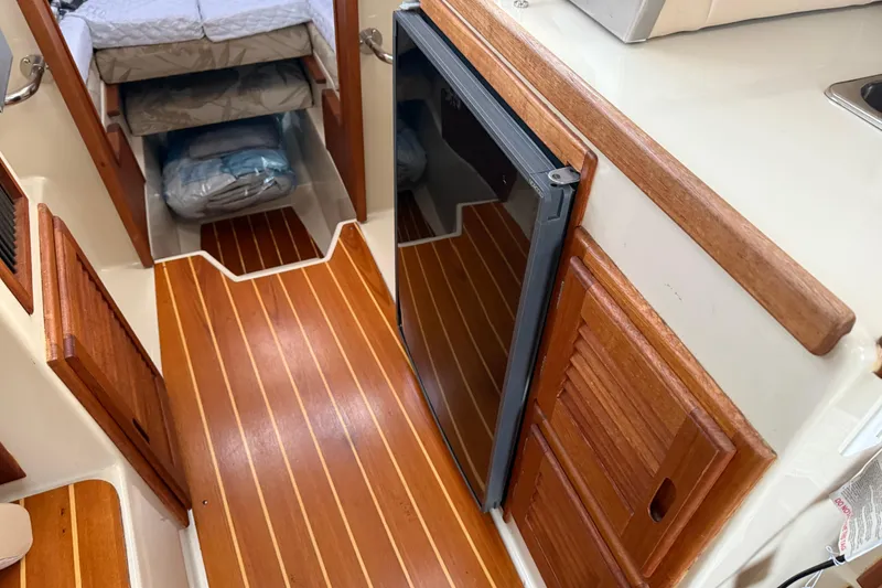 Slide: The Image of Interior of 2008 Ranger Tugs R-25 with wood flooring and compact cabin space. - 27