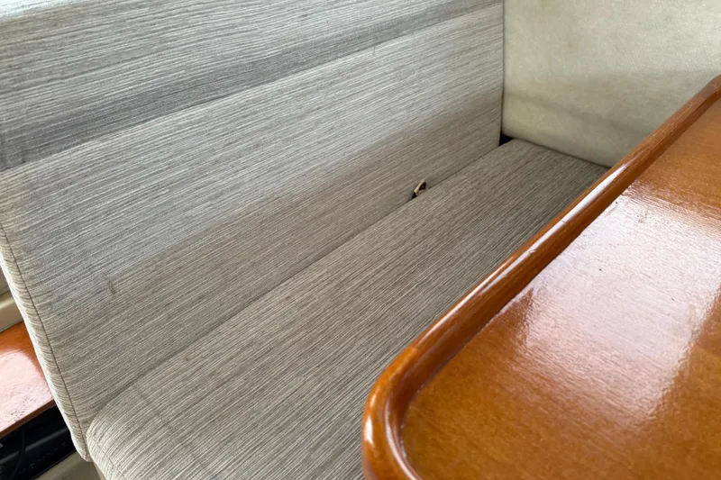 Slide: The Image of Gray fabric seating and wooden table inside a 2008 Ranger Tugs R-25 boat. - 29