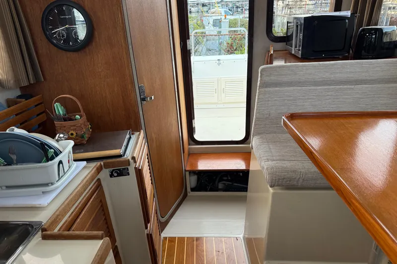 Slide: The Image of Interior of 2008 Ranger Tugs R-25 boat with wooden finishes and seating area. - 30