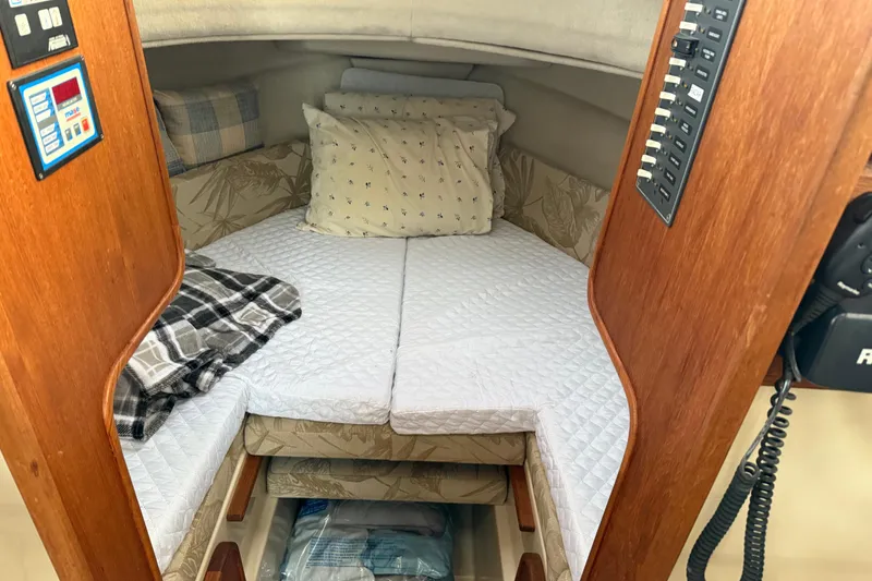 Slide: The Image of Cozy cabin interior of 2008 Ranger Tugs R-25 with bed and control panel. - 35