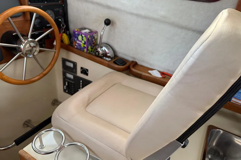 Slide: The Image of Captain's seat and steering wheel of 2008 Ranger Tugs R-25 boat interior. - 38