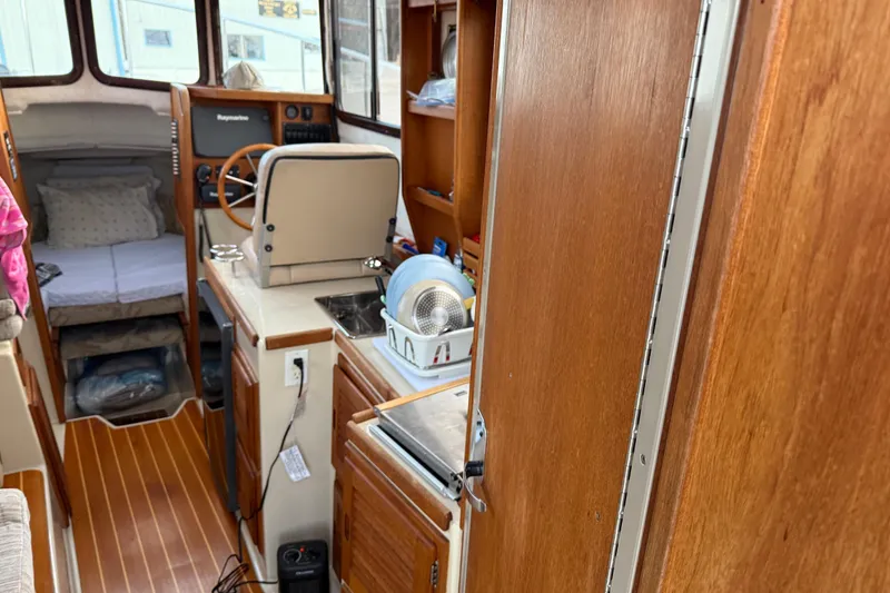 Slide: The Image of Interior of 2008 Ranger Tugs R-25 boat with cozy cabin and wooden finishes. - 40
