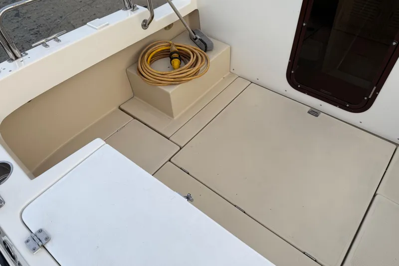 Slide: The Image of 2008 Ranger Tugs R-25 boat deck with coiled hose and storage compartments. - 45