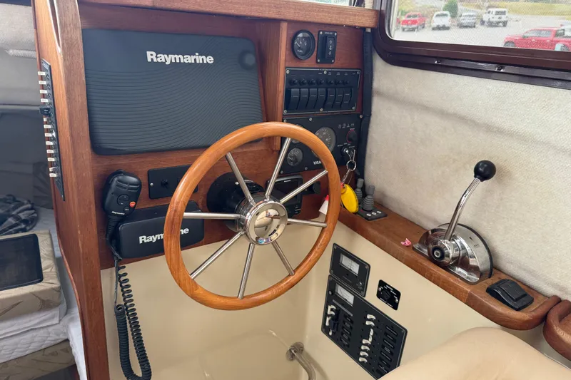 Slide: The Image of 2008 Ranger Tugs R-25 helm with Raymarine electronics and wooden steering wheel. - 5