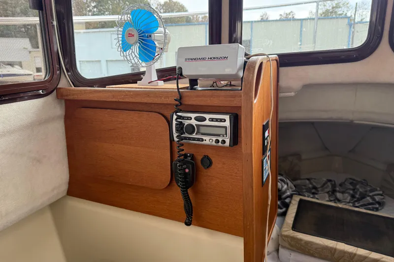 Slide: The Image of Interior of 2008 Ranger Tugs R-25 with radio, fan, and wooden paneling. - 6