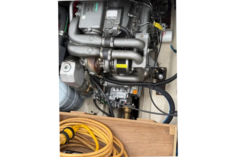 Slide: The Image of Engine compartment of a 2008 Ranger Tugs R-25 boat with visible hoses and components. - 8