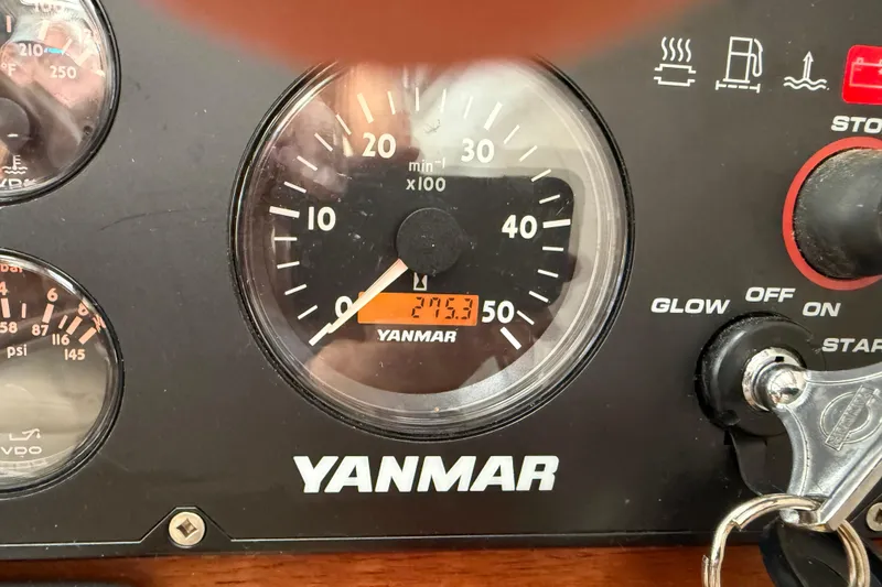 Slide: The Image of Yanmar engine control panel on 2008 Ranger Tugs R-25 boat, showing tachometer and key ignition. - 9