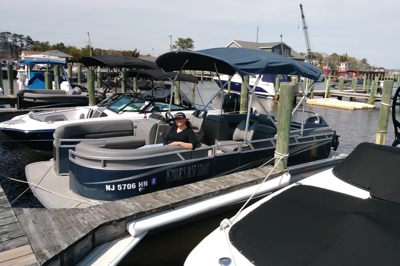 The Image of 2021 Avalon Catalina Quad Lounger boat docked at marina with person relaxing onboard. - 0