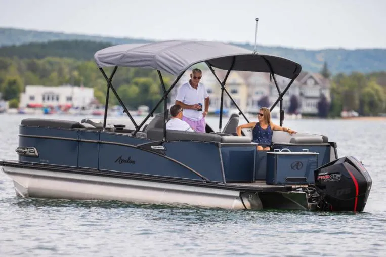 Slide: The Image of 2021 Avalon Catalina Quad Lounger boat with Mercury outboard motor docked on a river. - 5