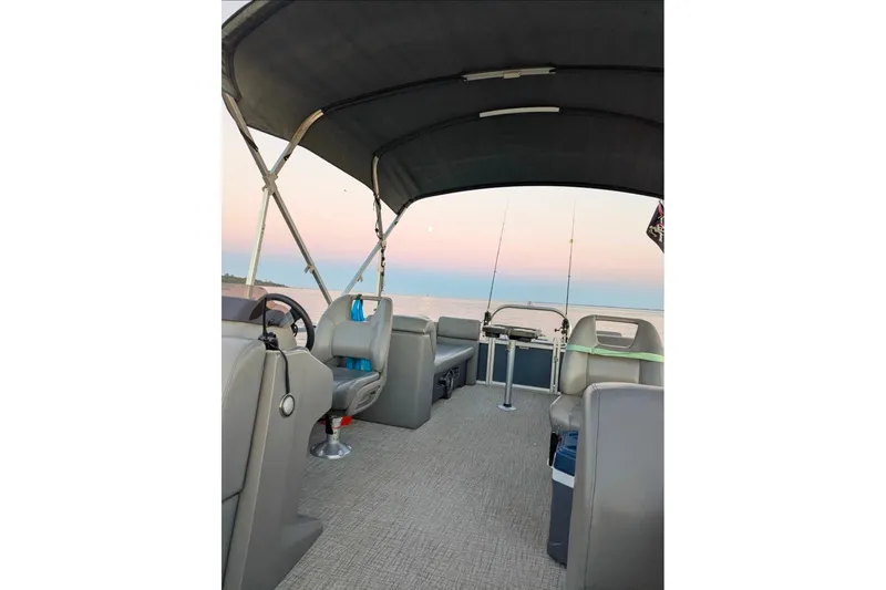 Slide: The Image of 2021 Avalon Catalina Quad Lounger boat docked at marina under blue sky. - 9