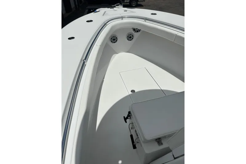 Slide: The Image of 2022 Onslow Bay 27 boat interior with white seating and speakers. - 10