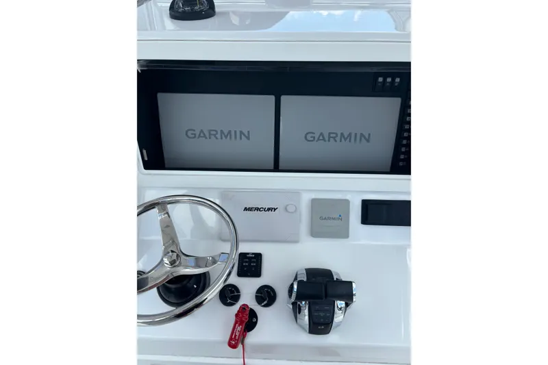 Slide: The Image of 2022 Onslow Bay 27 boat dashboard with Garmin displays and Mercury controls. - 3