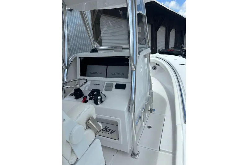 Slide: The Image of 2022 Onslow Bay 27 boat console with Garmin displays and steering wheel. - 7