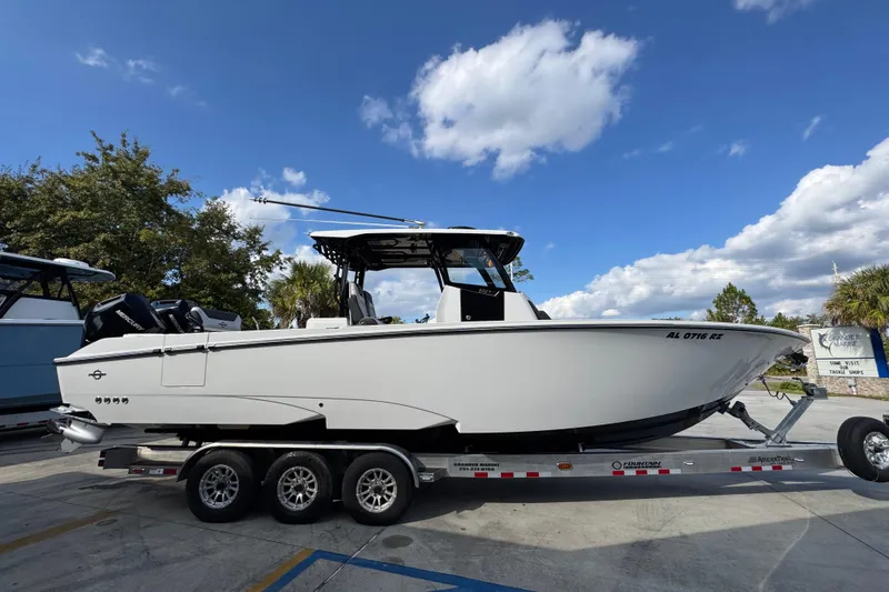 Slide: The Image of 2025 Fountain 32 NX boat on trailer under blue sky. - 10
