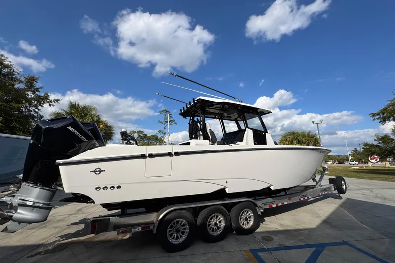 Slide: The Image of 2025 Fountain 32 NX boat on trailer under blue sky with clouds. - 11