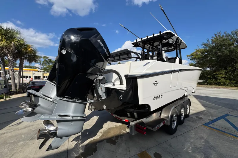 Slide: The Image of 2025 Fountain 32 NX boat with dual Mercury outboard engines on a trailer. - 12