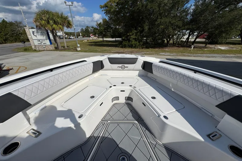 Slide: The Image of 2025 Fountain 32 NX boat interior with white seating and modern design. - 16