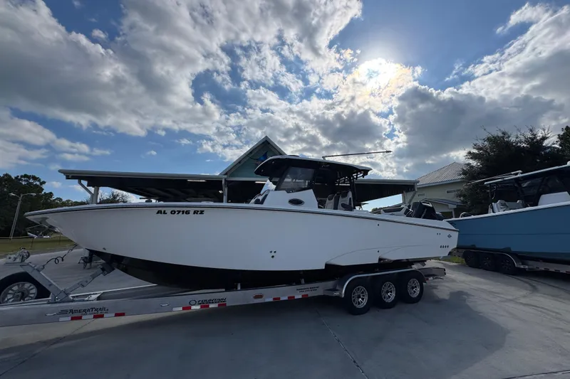 Slide: The Image of 2025 Fountain 32 NX boat on trailer under cloudy sky. - 2