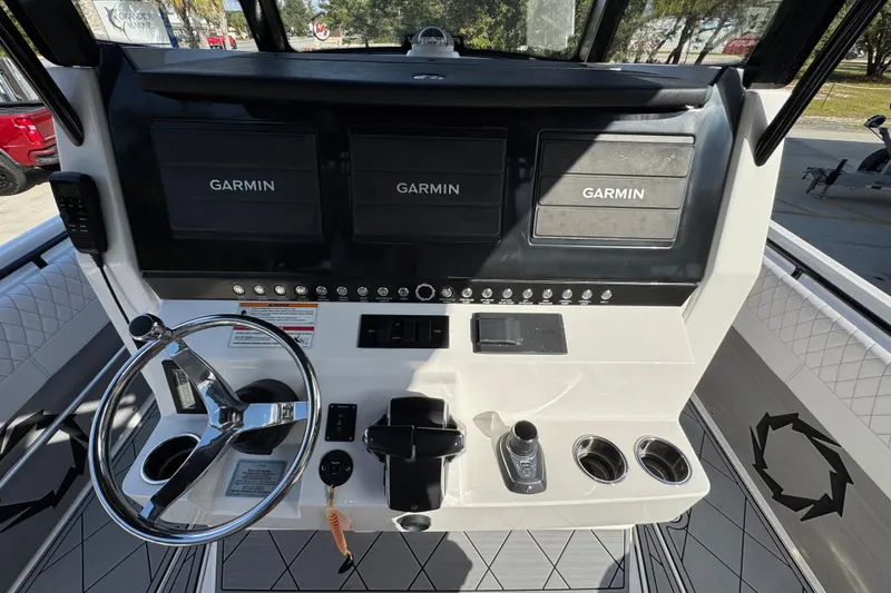 Slide: The Image of 2025 Fountain 32 NX boat dashboard with Garmin displays and steering wheel. - 28